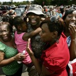 Sgt. Glenn Caramba, center, of Manhattan is hugged by daughter Yema Caramba, 11, as he is greeted by his family including, mother, Elizabeth Caramba, left, wife Lynda Caramba, and daughter Samia Caramba, right, Monday, May 25, 2009, at the U.S. Army's Fort Dix in Wrightstown, N.J. Caramba is one of nearly 400 New Jersey Army National Guard soldiers of the 50th Infantry Brigade Combat Team returning on the Memorial Day holiday from duty in Iraq. (AP Photo/Mel Evans)