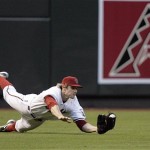 Arizona Diamondbacks left fielder Eric Byrnes dives to make a catch on a fly ball for an out, hit by San Diego Padres' Chris Burke in the second inning of a baseball game Wednesday, May 27, 2009, in Phoenix. (AP Photo/Paul Connors)