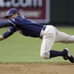 San Diego Padres shortstop Chris Burke dives to make the stop on a ground ball for an out, hit by Arizona Diamondbacks' Ryan Roberts in the third inning of a baseball game Wednesday, May 27, 2009, in Phoenix. (AP Photo/Paul Connors)