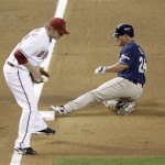 San Diego Padres' Brian Giles, right, slides safely into third as Arizona Diamondbacks third baseman Mark Reynolds, left, fields the throw on a triple by Giles in the sixth inning of a baseball game Wednesday, May 27, 2009, in Phoenix. (AP Photo/Paul Connors)