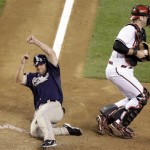 San Diego Padres' Kevin Kouzmanoff, left, slides safely home behind Arizona Diamondbacks catcher Chris Snyder, right, to score a run in the eighth inning of a baseball game Wednesday, May 27, 2009, in Phoenix. The Padres won 8-5. (AP Photo/Paul Connors)