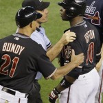 Arizona Diamondbacks' Justin Upton, right, is restrained by umpire Phil Cuzzi, center left, and Diamondbacks coach Lorenzo Bundy (21) after Upton had words with Atlanta Braves' David Ross in the sixth inning of a baseball game, Saturday, May 30, 2009, in Phoenix. (AP Photo/Ross D. Franklin)
