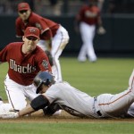 Arizona Diamondbacks' Stephen Drew, left, tags out San Francisco Giants' Kevin Frandsen as he tries to stretch a single into a double in the second inning of a baseball game Tuesday, June 9, 2009, in Phoenix. (AP Photo/Ross D. Franklin)