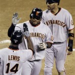 San Francisco Giants' Pablo Sandoval, center, is congratulated by teammates Randy Winn, top right, and Freddy Lewis (14) after Sandoval's two-run home run against the Arizona Diamondbacks in the fifth inning of a baseball game Tuesday, June 9, 2009, in Phoenix. (AP Photo/Ross D. Franklin)