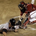 San Francisco Giants' Eli Whiteside, left, scores ahead of the tag by Arizona Diamondbacks' Miguel Montero in the sixth inning of a baseball game Tuesday, June 9, 2009, in Phoenix. (AP Photo/Ross D. Franklin)