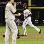 Arizona Diamondbacks' Justin Upton, right, rounds the bases after hitting a home run against San Francisco Giants' Jonathan Sanchez, left, in the third inning of a baseball game Thursday, June 11, 2009, in Phoenix. (AP Photo/Ross D. Franklin)