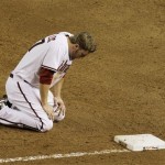 Arizona Diamondbacks' Mark Reynolds kneels at first base after being picked off against the San Francisco Giants' in the fifth inning of a baseball game Thursday, June 11, 2009, in Phoenix. (AP Photo/Ross D. Franklin)