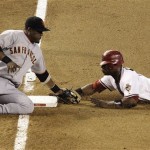 Arizona Diamondbacks' Justin Upton is caught stealing at third base as San Francisco Giants' Juan Uribe applies the tag in the seventh inning of a baseball game Thursday, June 11, 2009, in Phoenix. (AP Photo/Ross D. Franklin)