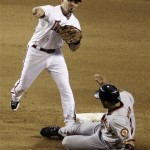 Arizona Diamondbacks' Augie Ojeda, top, throws to first after forcing out San Francisco Giants' Randy Winn in the eighth inning of a baseball game Thursday, June 11, 2009, in Phoenix. (AP Photo/Ross D. Franklin)