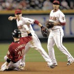 Arizona Diamondbacks' Stephen Drew, center, forces out Houston Astros' Jeff Keppinger (28) to start a double play hit into by Astros' Humberto Quintero (not shown) during the fifth inning of an MLB baseball game Friday, June 12, 2009, in Phoenix. At right is Diamodbacks' Felipe Lopez. (AP Photo/Matt York)