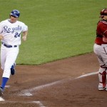 Kansas City Royals' Mark Teahen (24) scores on a single by David DeJesus while Arizona Diamondbacks catcher Miguel Montero waits for the throw during the second inning of a baseball game Tuesday, June 16, 2009, in Kansas City, Mo. (AP Photo/Charlie Riedel)