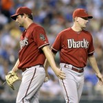 Arizona Diamondbacks starting pitcher Doug Davis, left, walks off the mound after handing the ball to manager A.J. Hinch during a pitching change in the sixth inning of a baseball game Tuesday, June 16, 2009, in Kansas City, Mo. (AP Photo/Charlie Riedel)