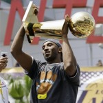 Los Angeles Lakers' Kobe Bryant holds up the Larry O'Brien trophy as the Lakers' NBA basketball world championship parade gets underway in Los Angeles, Wednesday, June 17, 2009 (AP Photo/Reed Saxon)