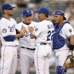 Kansas City Royals manager Trey Hillman (22) talks with starting pitcher Luke Hochevar, left , as Billy Butler, second from left, and catcher Brayan Pena, right, look on after Arizona Diamondbacks' Gerardo Parra hit a two-run triple in the third inning of a baseball game Thursday, June 18, 2009, in Kansas City, Mo. (AP Photo/Ed Zurga)