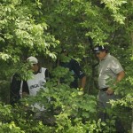 Phil Mickelson searches for his lost ball with several caddies in the woods off of the 13th fairway during the first round of the U.S. Open Golf Championship at Bethpage State Park's Black Course in Farmingdale, N.Y., Friday, June 19, 2009. (AP Photo/Matt Slocum)