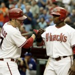 Arizona Diamondbacks' Mark Reynolds, left, celebrates his two-run home run against the Texas Rangers with teammate Justin Upton, in the first inning of a baseball game Thursday, June 25, 2009, in Phoenix. (AP Photo/Ross D. Franklin)