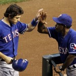 Texas Rangers' Ian Kinsler, left, gets a high-five from manager Ron Washington after Kinsler scores a run against the Arizona Diamondbacks in the third inning of a baseball game Thursday, June 25, 2009, in Phoenix. (AP Photo/Ross D. Franklin)
