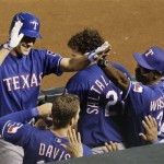 Texas Rangers' David Murphy, left, gets high-fives from Chris Davis, bottom left, Jarrod Saltalamacchia, middle, and manager Ron Washington after Murphy's home run against the Arizona Diamondbacks in the 12th inning of a baseball game Thursday, June 25, 2009, in Phoenix. (AP Photo/Ross D. Franklin)