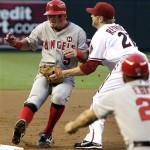 Los Angeles Angels' Jeff Mathis, left, gets tagged out by Arizona Diamondbacks' Mark Reynolds, top right, as Angels third base coach Dino Ebel looks on in the second inning of a baseball game Friday, June 26, 2009, in Phoenix. (AP Photo/Ross D. Franklin)