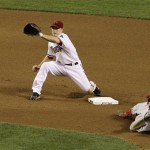 Los Angeles Angels' Erick Aybar, right, steals second base as Arizona Diamondbacks' Stephen Drew waits for the ball in the seventh inning of a baseball game Friday, June 26, 2009, in Phoenix. (AP Photo/Ross D. Franklin)