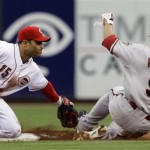 Cincinnati Reds shortstop Jerry Hairston Jr. (15) tags out Arizona Diamondbacks' Gerardo Parra (9) trying to steal second base in the second inning of a baseball game on Wednesday, July 1, 2009, in Cincinnati. (AP Photo/Al Behrman)