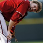 Arizona Diamondbacks third baseman Mark Reynolds reacts after falling into the crowd to field a foul ball against the Colorado Rockies in the second inning of a baseball game in Denver on Tuesday, July 21, 2009. (AP Photo/David Zalubowski)