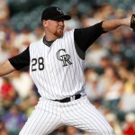 Colorado Rockies starting pitcher Aaron Cook works against the Arizona Diamondbacks in the first inning of a baseball game in Denver on Tuesday, July 21, 2009. (AP Photo/David Zalubowski)