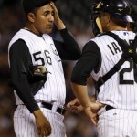 Colorado Rockies relief pitcher Franklin Morales, left, confers with catcher Chris Iannetta, front right,and pitching coach Bob Apodaca after Morales loaded the bases against the Arizona Diamondbacks in the seventh inning of a baseball game in Denver on Tuesday, July 21, 2009. (AP Photo/David Zalubowski)