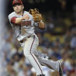 Arizona Diamondbacks third baseman Mark Reynolds throws back to first for the out after fielding a bunt by Los Angeles Dodgers' Rafael Furcal during the fifth inning of a baseball game, Thursday, Sept. 3, 2009, in Los Angeles. (AP Photo/Gus Ruelas)