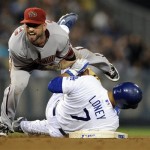 Los Angeles Dodgers' James Loney (7) breaks up a double play throw by Arizona Diamondbacks second baseman Ryan Roberts on an RBI fielders choice by Los Angeles Dodgers' Ronnie Belliard in the sixth inning of a baseball game, Thursday, Sept. 3, 2009, in Los Angeles. (AP Photo/Gus Ruelas)