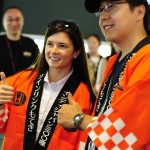 Driver Danica Patrick of the United States wearing a happi coat, poses with a fan who gave it to her, during an event to meet fans, ahead of the IndyCar Series' Indy Japan 300 mile auto race scheduled on Sunday, on the 1.5-mile oval track at Twin Ring Motegi in Motegi, northeast of Tokyo, Thursday, Sept. 17 , 2009. Patrick won last year's race in Japan and became the first woman to win an IRL race. (AP Photo/Shuji Kajiyama)