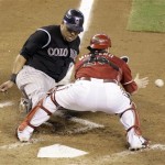 Colorado Rockies' Yorvit Torrealba, left, 
slides safely into home plate before Arizona 
Diamondbacks catcher Miguel Montero can field 
the throw on a sacrifice bunt by Rockies' Clint 
Barmes in the seventh inning of a baseball game 
Sunday, Sept. 20, 2009, in Phoenix. (AP 
Photo/Paul Connors)