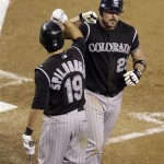 Colorado Rockies' Jason Giambi, right, is 
congratulated by teammate Ryan Slipborghs, 
left, while trotting back to the dugout after 
hitting a two-run home run off Arizona 
Diamondbacks pitcher Dan Haren in the eighth 
inning of a baseball game Sunday, Sept. 20, 
2009, in Phoenix. (AP Photo/Paul Connors)