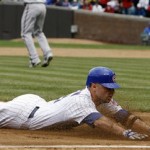 Chicago Cubs' Reed Johnson slides into third base after hitting a two-run triple against the Arizona Diamondbacks during the fourth inning of a baseball game in Chicago, Saturday, Oct. 3, 2009.(AP Photo/Nam Y. Huh)
