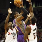 Phoenix Suns Amare Stoudemire (1) drives to the basket as Portland Trail Blazers Martell Webster (23) and teammate Greg Oden (52) defend in the first quarter of their NBA preseason basketball game Wednesday, Oct. 14, 2009, in Portland, Ore. (AP Photo/Rick Bowmer)