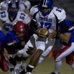 Chandler quarterback Brett Hundley tries to pull away from a Mountain View defender during the Wolves' 45-42 victory. (Photo by Matt Pavelek, East Valley Tribune)