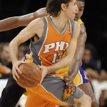 Los Angeles Lakers center Andrew Bynum, back, reaches in as Phoenix Suns guard Steve Nash (13) looks to pass in the first half of a NBA basketball game, Thursday, Nov. 12, 2009, in Los Angeles. (AP Photo/Gus Ruelas)