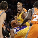 Los Angeles Lakers guard Kobe Bryant, center, is double teamed by Phoenix Suns guard Steve Nash (13) and Phoenix Suns guard Jason Richardson (23) in the first half of a NBA basketball game, Thursday, Nov. 12, 2009, in Los Angeles. (AP Photo/Gus Ruelas)