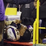 Minnesota Vikings' E.J. Henderson (56) is comforted by a teammate as he is carted off the field after an injury to his leg in the fourth quarter during an NFL football game against the Arizona Cardinals Sunday, Dec. 6, 2009, in Glendale, Ariz. The Cardinals defeated the Vikings 30-17. (AP Photo/Ross D. Franklin)
