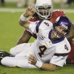Minnesota Vikings' Brett Favre (4) gets up off the ground after being knocked down by Arizona Cardinals' Darnell Dockett in the third quarter during an NFL football game Sunday, Dec. 6, 2009, in Glendale, Ariz. The Cardinals defeated the Vikings 30-17. (AP Photo/Ross D. Franklin)