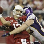 Arizona Cardinals' Kurt Warner, left, just gets a pass off as he gets hit by Minnesota Vikings' Jared Allen in the fourth quarter during an NFL football game Sunday, Dec. 6, 2009, in Glendale, Ariz. The Cardinals defeated the Vikings 30-17. (AP Photo/Ross D. Franklin)