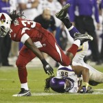 Arizona Cardinals running back Tim Hightower (34) escapes the tackle of Minnesota Vikings linebacker E.J. Henderson during the second half of an NFL football game Sunday, Dec. 6, 2009 in Glendale, Ariz. Henderson was injured on the play and was taken off the field. The Cardinals won 30-17. (AP Photo/Matt York)