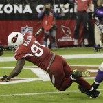 Arizona Cardinals' Anquan Boldin (81) dives for a touchdown as Minnesota Vikings' E.J. Henderson runs in late to defend in the second quarter during an NFL football game Sunday, Dec. 6, 2009, in Glendale, Ariz. (AP Photo/Ross D. Franklin)