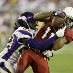 Arizona Cardinals wide receiver Larry Fitzgerald (11) pulls in a pass as Minnesota Vikings cornerback Benny Sapp defends during the first half of an NFL football game Sunday, Dec. 6, 2009 in Glendale, Ariz. (AP Photo/Paul Connors)