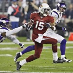 Arizona Cardinals wide receiver Steve Breaston (15) returns a punt to the two yard line to set up a score as Minnesota Vikings safety Jamarca Sanford and Ben Leber defend during the first half of an NFL football game Sunday, Dec. 6, 2009 in Glendale, Ariz. (AP Photo/Ross D. Franklin)
