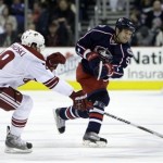 Columbus Blue Jackets' Fedor Tyutin, right, of Russia, clears the puck past Phoenix Coyotes' Lauri Korpikoski, of Finland, during the second period of an NHL hockey game Thursday, Dec. 17, 2009, in Columbus, Ohio. (AP Photo/Jay LaPrete)