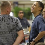 President Barack Obama, and first lady Michelle Obama, laugh as they greet marines during Christmas dinner at Anderson Hall on Marine Corps Base Hawaii in Kailua, Hawaii Friday, Dec. 25, 2009. The Obamas are in Hawaii for the holidays. (AP Photo/Alex Brandon)