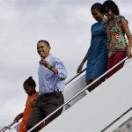 President Barack Obama, holds the hand of Sasha Obama, 8, as they and Michelle Obama and Malia Obama, 11, walk down the steps of Air Force One at Hickam Air Force Base in Honolulu Thursday, Dec. 24, 2009. They are in Hawaii for the holidays. (AP Photo/Alex Brandon)