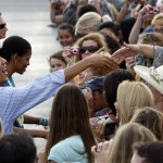 President Barack Obama and first lady Michelle Obama, greet supporters after arriving at Hickam Air Force Base in Honolulu Thursday, Dec. 24, 2009. They are in Hawaii for the holidays. (AP Photo/Alex Brandon)