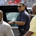 President Barack Obama, center, smiles as he get in the car after going to the movies in Kaneohe, Hawaii Thursday, Dec. 31, 2009. The Obamas are in Hawaii for the holidays. (AP Photo/Alex Brandon)